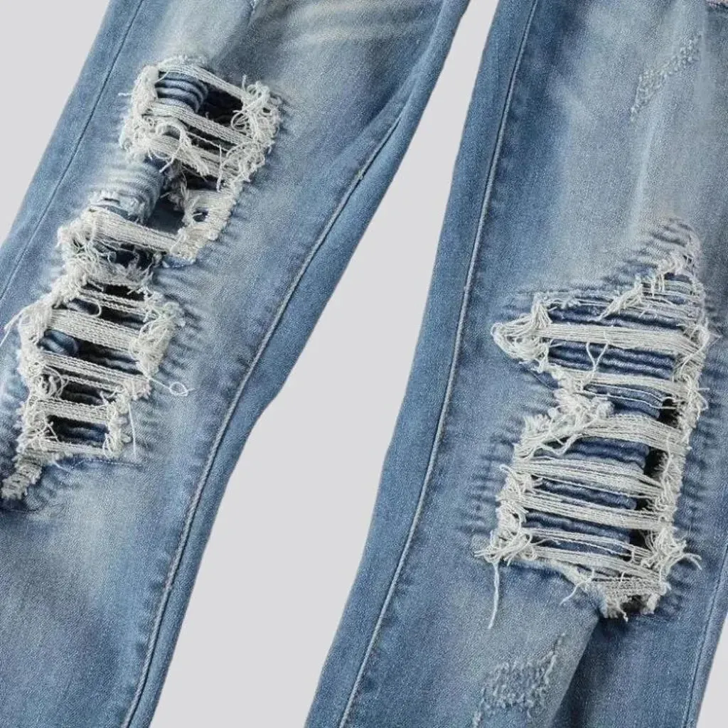 Damaged men's whiskered jeans